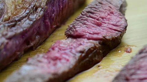 Slicing medium rare steak, close up, selective focus. Stock Footage 254873004