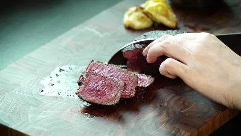 Slicing Medium Rare Steak on Cutting Board – Juicy Beef Close Up 4K Stock Footage 334358116
