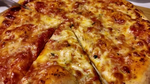 Slicing mozzarella pizza close up slow motion. Delicious Italian pizza from the Stock Footage 270472047