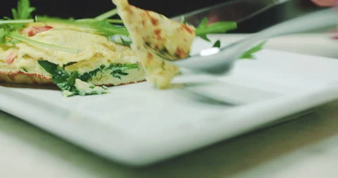 Slicing Omelet with Rocket, Salmon, and Zucchini Stock Footage 304881405