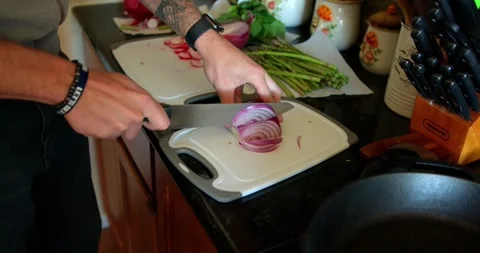 Slicing an onion on a cutting board Stock Footage 149180358