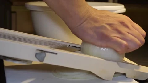 Slicing Onion Thinly with Mandoline Vegetable Slicer in Kitchen, Side View Close Stock-Footage 347689378