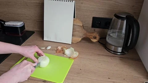 Slicing Onions on Cutting Board in Kitchen Scene Stock Footage 305750545