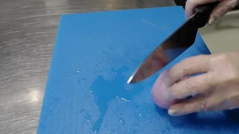 Slicing onions in a restaurant while preparing a Greek salad. Stock Footage 114890113