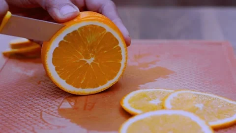 Slicing orange on a cutting board Stock Footage 233556818