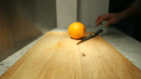 Slicing an orange in half Stock Footage 544571