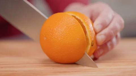 Slicing an Orange in Half Move Left from Oranges Stock Footage 155112082