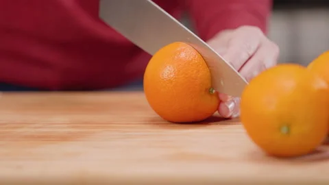 Slicing an Orange in Half Rack Focus Move Left from Oranges Video stock 155112746