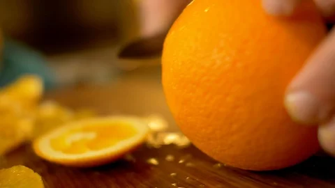Slicing orange in kitchen Stock Footage