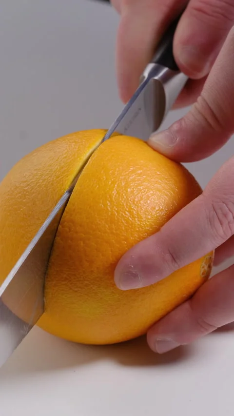 Slicing an Orange with a Knife Stock Footage 302507291