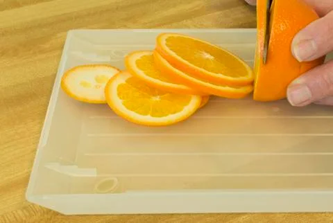 Slicing an orange Photos