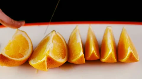 Slicing orange slices on the table Stock Footage 144213639