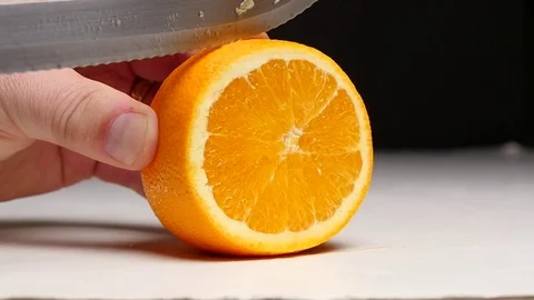 Slicing an orange in slow motion Stock Footage 77812951