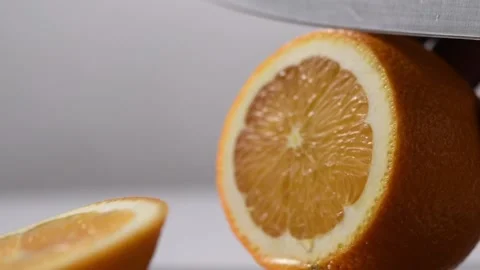 Slicing an orange in slow motion Stock Footage 131978173