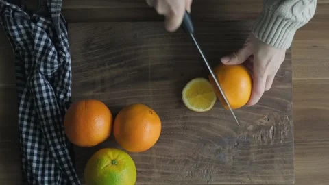 Slicing oranges with on the cutting board Stock Footage 262310488