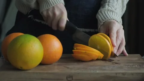 Slicing oranges with on the cutting board Stock Footage 262310633