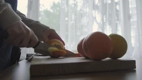 Slicing oranges with on the cutting board Stock Footage 262310751
