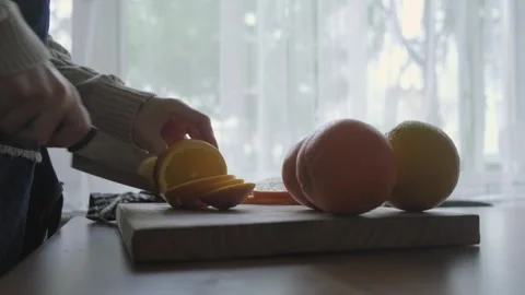 Slicing oranges with on the cutting board Stock Footage 262310824