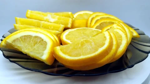 Slicing oranges on a plate rotates clockwise Stock Footage 168267108