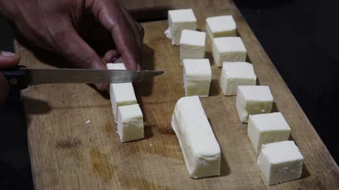 Slicing the paneer into cube to make the paneer tikka. Cubing the paneer. Stock Footage 238847392