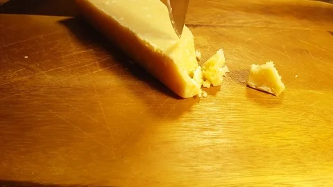 Slicing parmesan cheese Stock Footage 83512971