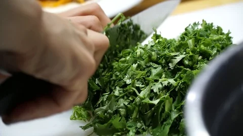 Slicing parsley in the kitchen Stock Footage 100629880