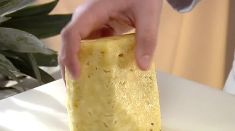 Slicing a peeled pineapple Stock Footage 8573859
