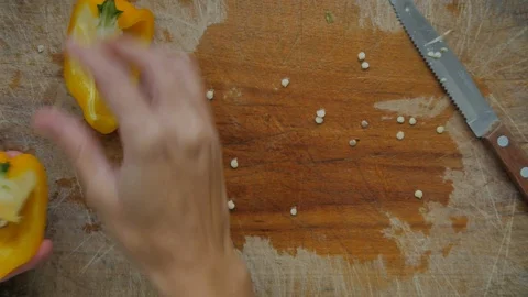 Slicing pepperoni, vegetable cooking, preparation of yellow and red peppers.  Stock Footage 118971622