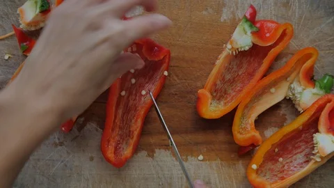 Slicing pepperoni, vegetable cooking, preparation of yellow and red peppers.  Stock Footage 118972050