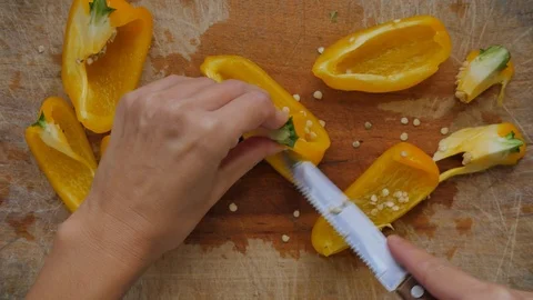 Slicing pepperoni, vegetable cooking, preparation of yellow and red peppers.  Stock Footage 118972215