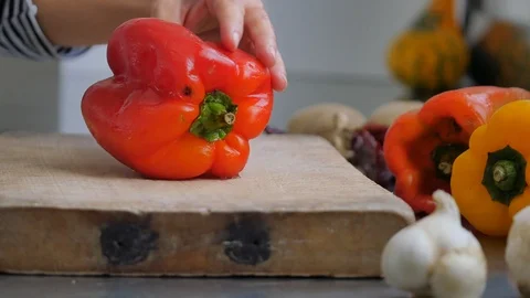 Slicing pepperoni, vegetable cooking, preparation of yellow and red peppers.  Stock Footage 118972431