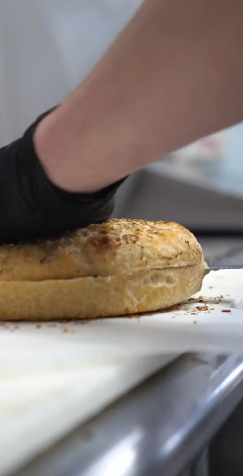 Slicing Piece Of bread In Two Pieces With Knife Stock Footage 138714204
