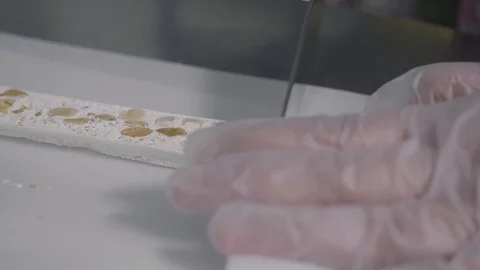 Slicing a piece of a torrone Stock Footage 129993381