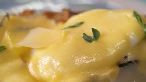 Slicing a poached egg with a knife on eggs benedict. Haute cuisine concept Stock Footage 105495845