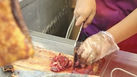 Slicing pork using a cleaver Stock Footage 272298459