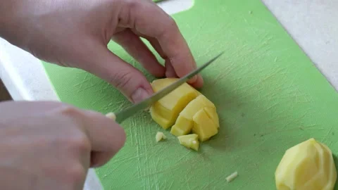 Slicing potatoes in the kitchen close-up slow mo Stock Footage 148390818
