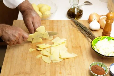 Slicing potatoes with sharp knife Stock Photos