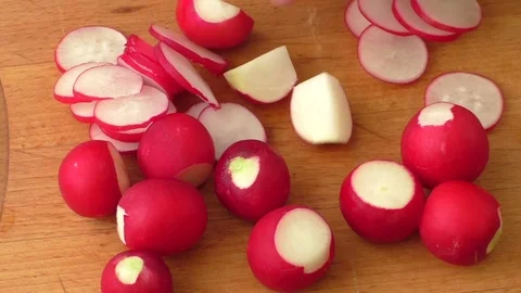 Slicing radish on a rustic wooden table Stock Footage 75186738