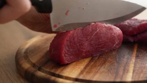 Slicing Raw Beef on Cutting Board. Stock Footage 256223894