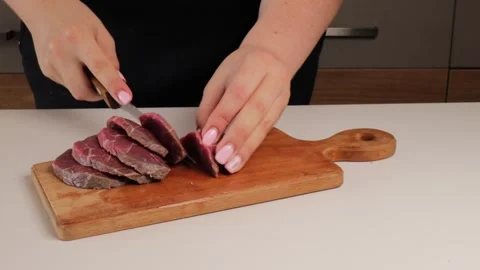 Slicing raw beef into pieces Stock Footage 316676862