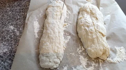 Slicing raw bread with a knife before baking Stock Footage 235344985