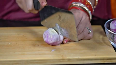 Slicing raw organic onion with large chopper blade on cutting board Stock Footage 335265927
