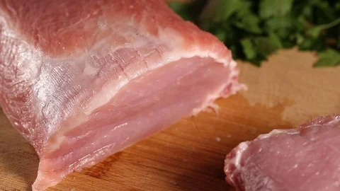Slicing raw pork meat Stock Footage 83182953
