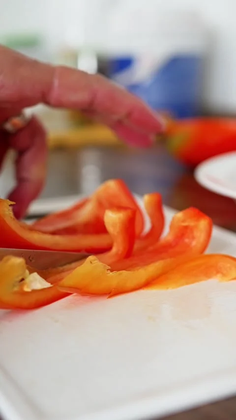 Slicing Red Bell Pepper An Exciting and Delicious Culinary Delight in Cooking Stock Footage 314512601