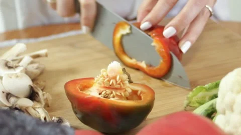 Slicing red fresh pepper. Concept of preparing vegetables for making salad Stock Footage 315028613