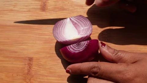 Slicing a red onion on a cutting board Stock Footage 332575904