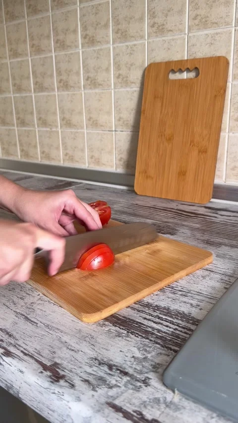 Slicing Red Tomato on Cutting Board Stock Footage 340340853