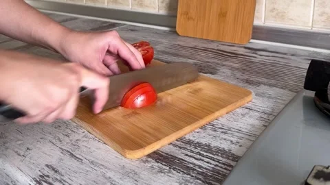 Slicing Red Tomato on Cutting Board Stock Footage 340340863