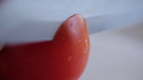 Slicing a red tomato with a knife, close up Video stock 47726870