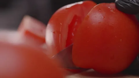 Slicing red tomatoes on a chopping board. Stock Footage 313971419